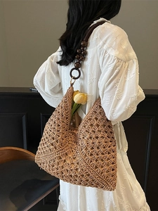 Handmade woven hobo straw bag with wooden bead straps for summer beach vacations