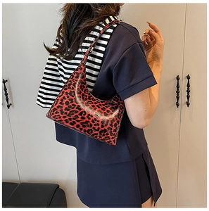 Close-up of a stylish leopard print hobo bag worn over the shoulder for a chic commute