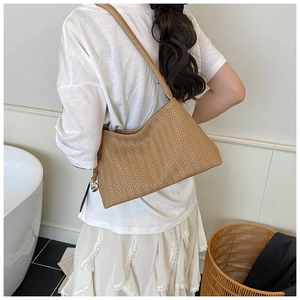 Detailed close-up showing the intricate herringbone woven texture of this light brown bag