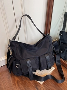 Large black nylon tote bag with multi-pockets and wide strap for daily commute