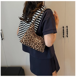 Detail showing high-capacity leopard print hobo bag with a stylish metal chain strap