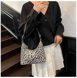 Detail of leopard print shoulder bag with metallic buckle adjustment on strap