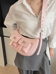 Pink crescent underarm bag with multi-pockets and silver hardware shown on a model