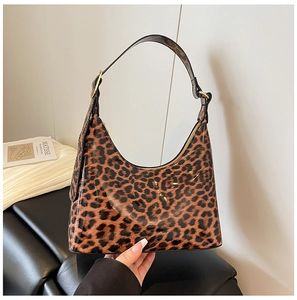 Detailed view of shiny leopard print hobo bag with polished finish and gold metal hardware