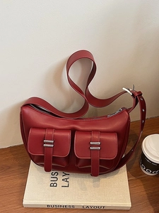 Dark red crescent shoulder bag with multi-pocket design and silver metal buckles