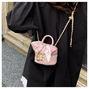 Pink quilted leather mini crossbody bag with silk scarf handle and gold chain strap