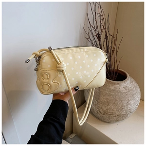 Détail du sac carré jaune à pois avec design numéro 8 et texture en cuir PU de qualité