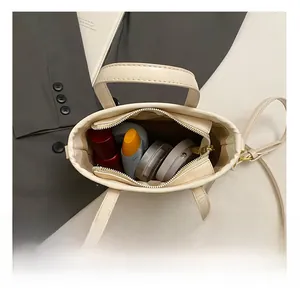 Internal view of beige leather handbag showing spacious capacity for cosmetics and accessories