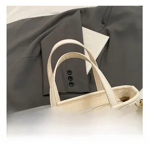 Close-up of stylish bucket bag with colorful graffiti art and polished gold hardware
