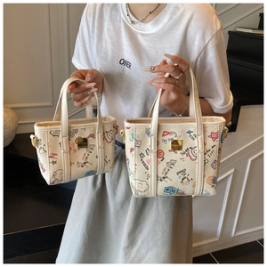 Detailed comparison showing two sizes of cream tote bags with colorful art graffiti prints