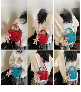 Detail showing red and teal bucket bags with cute dog charms in various carrying styles