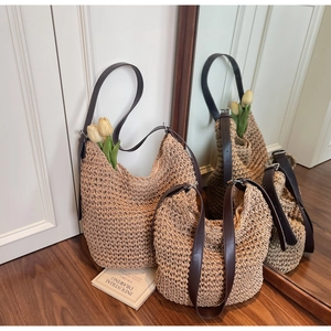 Close-up of beige woven tote bags with leather straps and honeycomb mesh texture