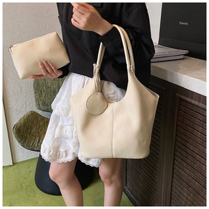 Chic beige tote bag set featuring pebbled leather texture and matching zipper pouch