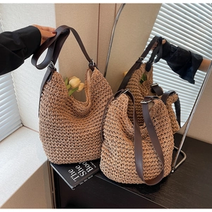 Detail of hand-woven straw tote with leather strap and interior fabric lining