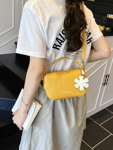 Yellow litchi pattern leather crossbody bag with flower charm and adjustable strap