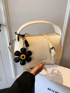Chic cream litchi texture top handle handbag with fashion floral pendant for women