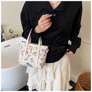 Detail of cream graffiti tote bag with colorful hand-drawn prints and fine leather handles