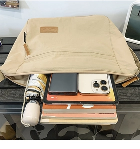 Detailed interior view of a beige nylon tote bag showing spacious capacity for gadgets