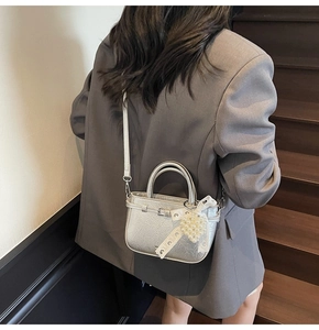 Silver metallic mini crossbody bag with pleat texture and pearl heart charm detail