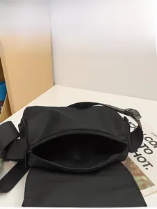 Internal capacity display of a black nylon messenger bag with spacious main compartment