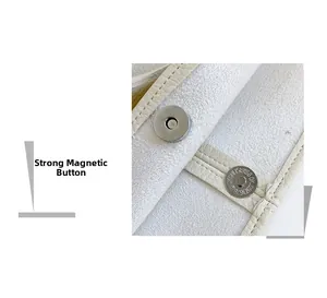 Detail of strong silver magnetic buckle on creamy white lychee grain leather tote bag
