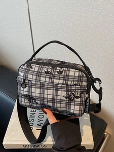 Minimalist black and white checkered canvas crossbody bag with adjustable black strap