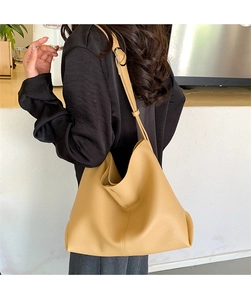 Close-up of mustard yellow hobo bag with litchi grain leather and wide adjustable strap
