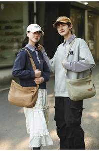 Outdoor street view of casual nylon crossbody messenger bags in brown and green