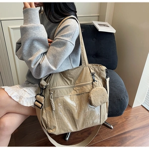 Detail of khaki nylon tote bag with PVC pocket and mini round coin purse attachment