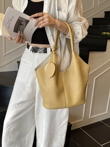 Chic yellow lychee grain leather tote bag with round pendant charm for casual style