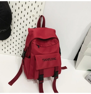 Close-up of red nylon backpack featuring TIANFLONG embroidery and buckle detail