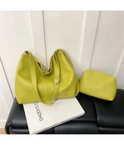 Detail of lime green leather tote set with pebble texture and adjustable silver buckle