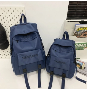 Detail view of durable navy blue nylon backpacks in two sizes with Tianflong embroidery