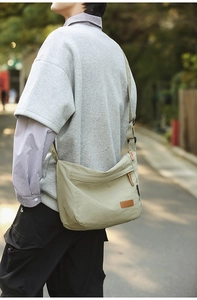 Detail of water-resistant green nylon crossbody bag with adjustable wide shoulder strap