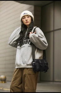 Street style outfit with black nylon messenger bag and gray letter printed sweatshirt