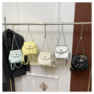 Detailed view of mini quilted backpacks in five colors with metal chain and turn-lock closure