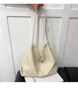 Detail of off-white lychee texture leather hobo bag with wide adjustable shoulder strap