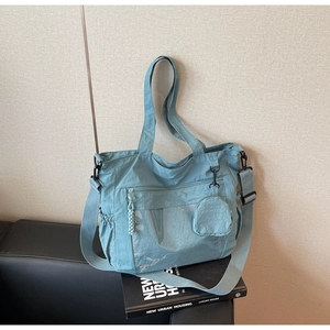 Detail of Morandi blue nylon tote bag with transparent pocket and round coin purse