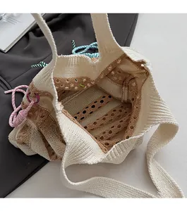 Detail of knitted tote bag showing spacious open compartment and woven texture