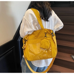 Detailed back view of a ginger yellow nylon tote bag with a clear PVC front pocket