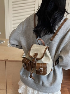 Retro canvas and leather backpack for women featuring a minimalist vintage drawstring design
