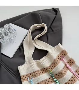 Detail showing the textured knit pattern and wide shoulder strap of the striped tote bag