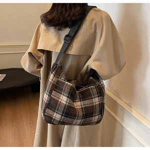 Vista dettagliata di una borsa a tracolla retrò a quadri marroni con cinturino