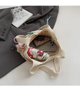 Macro shot of large capacity beige knit tote bag showing spacious interior and crochet detail