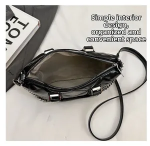 Internal view showing the spacious minimalist compartment of the black quilted handbag