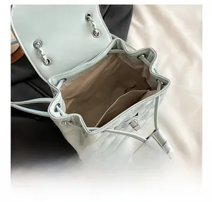 Detail view of the quilted backpack interior with drawstring closure and chain strap