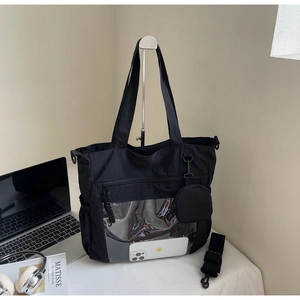 Detail of black nylon tote bag with transparent PVC pocket and detachable small coin purse