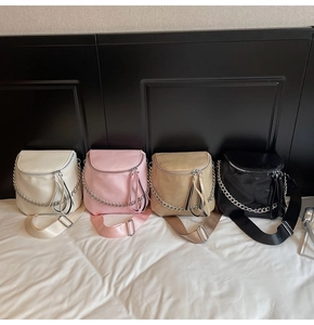 Detail of trendy saddle bags with silver chain decor and wide woven straps in four colors