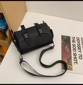 Detail of black tactical messenger bag with adjustable straps and high-density nylon fabric