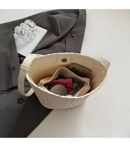 Interior view of cream woven bucket bag showing spacious storage for essentials